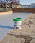 PolySeal Waterproofing Kit on a South African flat concrete roof — cured grey waterproof membrane on one side, bare cracked concrete on the other